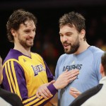               FILE - In this Nov. 15, 2013, file photo, Los Angeles Lakers' Pau Gasol, left, and his brother, Memphis Grizzlies' Marc Gasol talk to referees before an NBA basketball game in Los Angeles. Gregg Popovich will coach the home team while brothers Pau and Marc Gasol will play for Team World in the NBA's first game in Africa. Popovich, the five-time champion from the San Antonio Spurs, will guide Team Africa in the Aug. 1 game in Johannesburg, the league announced Thursday, July 16, 2015.  (AP Photo/Jae C. Hong, File)
            