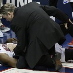
              Atlanta Hawks forward DeMarre Carroll lies on the court and is attended to by medical staff after being injured against the Cleveland Cavaliers during the second half in Game 1 of the Eastern Conference finals of the NBA basketball playoffs, Wednesday, May 20, 2015, in Atlanta. (AP Photo/David Goldman)
            