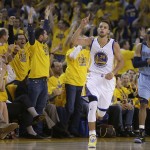 
              Fans cheer as Golden State Warriors guard Stephen Curry (30) reacts after scoring in front of Memphis Grizzlies guard Vince Carter during the first half of Game 5 in a second-round NBA playoff basketball series in Oakland, Calif., Wednesday, May 13, 2015. (AP Photo/Ben Margot)
            