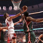 
              Chicago Bulls forward Pau Gasol, middle, scores between Milwaukee Bucks center Zaza Pachulia, left, and Khris Middleton, during the first half in Game 5 of the NBA basketball playoffs Monday, April 27, 2015, in Chicago. (AP Photo/Charles Rex Arbogast)
            