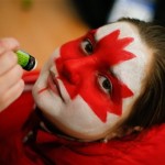 13-year-old Nastya Makarycheva gets her face painted with the Canadian maple leaf before the men's semifinal ice hockey game against the USA at the 2014 Winter Olympics, Friday, Feb. 21, 2014, in Sochi, Russia. (AP Photo/Mark Humphrey)