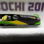 The team from Jamaica JAM-1, piloted by Winston Watts and brakeman Marvin Dixon, take a curve during the men's two-man bobsled competition at the 2014 Winter Olympics, Sunday, Feb. 16, 2014, in Krasnaya Polyana, Russia. (AP Photo/Natacha Pisarenko)