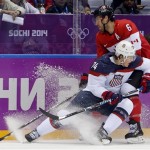 USA forward T.J. Oshie and Canada defenseman Shea Weber battle for control of the puck during the first period of a men's semifinal ice hockey game at the 2014 Winter Olympics, Friday, Feb. 21, 2014, in Sochi, Russia. (AP Photo/Petr David Josek)