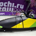 The two-man team from Jamaica JAM-1, piloted by Winston Watts, start their second run during the men's two-man bobsled training at the 2014 Winter Olympics, Thursday, Feb. 13, 2014, in Krasnaya Polyana, Russia. (AP Photo/Michael Sohn)