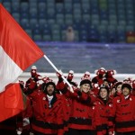 Hayley Wickenheiser of Canada carries the national flag as she leads the team during the opening ceremony of the 2014 Winter Olympics in Sochi, Russia, Friday, Feb. 7, 2014. (AP Photo/Mark Humphrey)