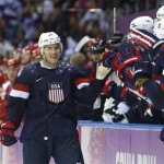 USA forward T.J. Oshie is greeted by treammates after scoring a goal during a shootout against Russia in overtime of a men's ice hockey game at the 2014 Winter Olympics, Saturday, Feb. 15, 2014, in Sochi, Russia. (AP Photo/Mark Humphrey)