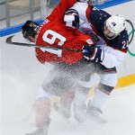 Canada defenseman Jay Bouwmeester and USA forward Ryan Callahan collide during the first period of the men's semifinal ice hockey game at the 2014 Winter Olympics, Friday, Feb. 21, 2014, in Sochi, Russia. (AP Photo/Matt Slocum)