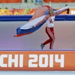 Russia's Olga Graf holds her national flag as she celebrates winning the bronze in the women's 3,000-meter speedskating race at the Adler Arena Skating Center during the 2014 Winter Olympics, Sunday, Feb. 9, 2014, in Sochi, Russia. (AP Photo/Patrick Semansky)