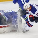 Slovenia goaltender Luka Gracnar dives on the puck in front of USA forward Paul Stastny during the 2014 Winter Olympics men's ice hockey game at Shayba Arena Sunday, Feb. 16, 2014, in Sochi, Russia. (AP Photo/Petr David Josek)