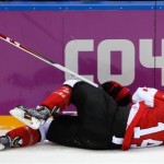 Chris Kunitz of Canada (14) lies on the ice after an injury during the second period of the men's gold medal ice hockey game against Sweden at the 2014 Winter Olympics, Sunday, Feb. 23, 2014, in Sochi, Russia. (AP Photo/Petr David Josek)