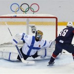 Finland goaltender Tuukka Rask blocks a shot by USA forward Patrick Kane during the first period of the men's bronze medal ice hockey game at the 2014 Winter Olympics, Saturday, Feb. 22, 2014, in Sochi, Russia. (AP Photo/David J. Phillip)