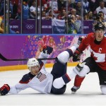 USA forward Paul Stastny trips over Canada forward Sidney Crosby during the second period of a men's semifinal ice hockey game at the 2014 Winter Olympics, Friday, Feb. 21, 2014, in Sochi, Russia. (AP Photo/Petr David Josek)
