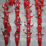 The Chinese team members wave their national flag and walk in the stadium during the opening ceremony of the 2014 Winter Olympics in Sochi, Russia, Friday, Feb. 7, 2014. (AP Photo/Charlie Riedel)