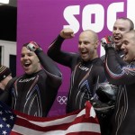 The team from the United States USA-2, with Nick Cunningham, Justin Olsen, Johnny Quinn and Dallas Robinson, react in the finish area after their second run during the men's four-man bobsled competition at the 2014 Winter Olympics, Saturday, Feb. 22, 2014, in Krasnaya Polyana, Russia. (AP Photo/Michael Sohn)