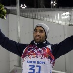 France's Martin Fourcade celebrates after winning the gold medal in the men's biathlon 20k individual race, at the 2014 Winter Olympics, Thursday, Feb. 13, 2014, in Krasnaya Polyana, Russia. (AP Photo/Lee Jin-man)