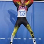 Felix Loch of Germany jumps onto the podium after he won the gold medal during the men's singles luge final at the 2014 Winter Olympics, Sunday, Feb. 9, 2014, in Krasnaya Polyana, Russia. (AP Photo/Michael Sohn)