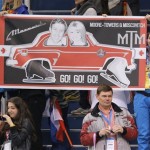 Volunteers hold a banner in support of Kirsten Moore-Towers and Dylan Moscovitch of Canada before they compete in the pairs short program figure skating competition at the Iceberg Skating Palace during the 2014 Winter Olympics, Tuesday, Feb. 11, 2014, in Sochi, Russia. (AP Photo/Vadim Ghirda)