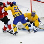 Matt Duchene of Canada (9) and Niklas Kronwall of Sweden (55) battle in front of the net as Goalkeeper Henrik Lundqvist of Sweden (30) keeps an eye on the puck during the third period of the men's gold medal ice hockey game at the 2014 Winter Olympics, Sunday, Feb. 23, 2014, in Sochi, Russia. (AP Photo/Petr David Josek)