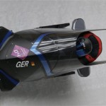 The team from Germany GER-1, piloted by Francesco Friedrich and brakeman Jannis Baecker, take a curve during the men's two-man bobsled competition at the 2014 Winter Olympics, Sunday, Feb. 16, 2014, in Krasnaya Polyana, Russia. (AP Photo/Michael Sohn)