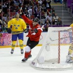 Canada forward Jonathan Toews, center, reacts upon scoring a goal against Sweden during the first period of the men's gold medal ice hockey game at the 2014 Winter Olympics, Sunday, Feb. 23, 2014, in Sochi, Russia. (AP Photo/Matt Slocum)