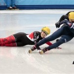 Valerie Maltais of Canada, left, crashes out as she competes in a women's 1000m short track speedskating semifinal at the Iceberg Skating Palace during the 2014 Winter Olympics, Friday, Feb. 21, 2014, in Sochi, Russia. (AP Photo/Ivan Sekretarev)