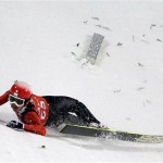  Switzerland's Simon Ammann crashes during a training session for the men's large hill ski jumping at the 2014 Winter Olympics, Thursday, Feb. 13, 2014, in Krasnaya Polyana, Russia. (AP Photo/Gregorio Borgia)