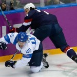 T. J. Oshie of the United States collides with Sami Vatanen of Finland during the first period of the men's bronze medal ice hockey game at the 2014 Winter Olympics, Saturday, Feb. 22, 2014, in Sochi, Russia. (AP Photo/Matt Slocum)