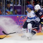 USA forward Blake Wheeler and Finland defenseman Sami Lepisto vie for the puck during the second period of the men's bronze medal ice hockey game at the 2014 Winter Olympics, Saturday, Feb. 22, 2014, in Sochi, Russia. (AP Photo/Petr David Josek)