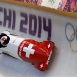 The two-man team from Switzerland SUI-1, piloted by Beat Hefti, races down the track during the men's two-man bobsled training at the 2014 Winter Olympics, Thursday, Feb. 13, 2014, in Krasnaya Polyana, Russia. (AP Photo/Natacha Pisarenko)