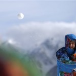 A volunteer throws a snowball prior to the mixed biathlon relay at the 2014 Winter Olympics, Wednesday, Feb. 19, 2014, in Krasnaya Polyana, Russia. (AP Photo/Felipe Dana)