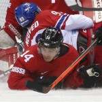 Switzerland forward Roman Wick gets tangled up with Czech Republic forward Petr Nedved in the third period of a men's ice hockey game at the 2014 Winter Olympics, Saturday, Feb. 15, 2014, in Sochi, Russia. Switzerland won 1-0. (AP Photo/Julio Cortez)