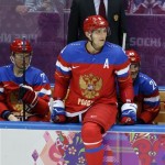 Russia forward Alexander Ovechkin watches play against Slovenia from the bench in the second period of a men's ice hockey game at the 2014 Winter Olympics, Thursday, Feb. 13, 2014, in Sochi, Russia. (AP Photo/Mark Humphrey)