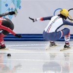Veronique Pierron of France, right, loses control as she competes with Marie-Eve Drolet of Canada in a women's 1000m short track speedskating quarterfinal at the Iceberg Skating Palace during the 2014 Winter Olympics, Friday, Feb. 21, 2014, in Sochi, Russia. (AP Photo/Ivan Sekretarev)