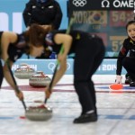 South Korea's skip Kim Jisun shouts instructions to her sweepers during women's curling competition against Switzerland at the 2014 Winter Olympics, Tuesday, Feb. 11, 2014, in Sochi, Russia. (AP Photo/Robert F. Bukaty)