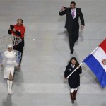 Lone athlete from Paraguay Julia Marino holds her country's national flag and enters the arena during the opening ceremony of the 2014 Winter Olympics in Sochi, Russia, Friday, Feb. 7, 2014. (AP Photo/Charlie Riedel)
