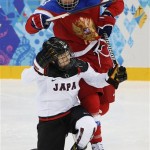 Iya Govrilova of Russia collides with Yuka Hirano of Japan during the 2014 Winter Olympics women's ice hockey game at Shayba Arena Sunday, Feb. 16, 2014, in Sochi, Russia. (AP Photo/Petr David Josek)
