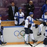 Team Finland watches as team Canada celebrates its 2-1 sudden death overtime victory in a men's ice hockey game at the 2014 Winter Olympics, Sunday, Feb. 16, 2014, in Sochi, Russia. (AP Photo/Julio Cortez)