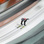 An unidentified athlete makes an attempt in the men's normal hill ski jumping training at the 2014 Winter Olympics, Thursday, Feb. 6, 2014, in Krasnaya Polyana, Russia. (AP Photo/Matthias Schrader)
