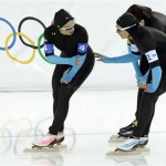U.S. speedskaters Jilleanne Rookard, left, Brittany Bowe, front right, and Heather Richardson catch their breath after the women's speedskating team pursuit quarterfinals at the Adler Arena Skating Center at the 2014 Winter Olympics, Friday, Feb. 21, 2014, in Sochi, Russia. (AP Photo/Matt Dunham)