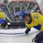  Emma Eliasson of Sweden crawls into the net after a puck on a Russian goal that was disallowed because it happened after the whistle during women's ice hockey game at the 2014 Winter Olympics, Thursday, Feb. 13, 2014, in Sochi, Russia. Russia defeated Sweden 3-1. (AP Photo/Brian Snyder, Pool)