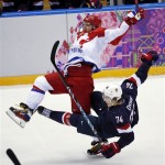 Russia forward Alexander Ovechkin is upended by USA forward T.J. Oshie in the third period of a men's ice hockey game at the 2014 Winter Olympics, Saturday, Feb. 15, 2014, in Sochi, Russia. (AP Photo/Petr David Josek)