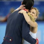 Tatiana Volosozhar and Maxim Trankov of Russia embrace after competing in the team pairs short program figure skating competition at the Iceberg Skating Palace during the 2014 Winter Olympics, Thursday, Feb. 6, 2014, in Sochi, Russia. (AP Photo/Bernat Armangue)