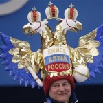 A man wears a hat in the shape of the coat of arms of Russia as he attends the men's short program figure skating competition at the Iceberg Skating Palace during the 2014 Winter Olympics, Thursday, Feb. 13, 2014, in Sochi, Russia. (AP Photo/Bernat Armangue)