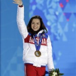 Women's free skate figure skating gold medalist Adelina Sotnikova of Russia waves during the medals ceremony at the 2014 Winter Olympics, Friday, Feb. 21, 2014, in Sochi, Russia. (AP Photo/Darron Cummings)