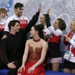Tessa Virtue and Scott Moir of Canada, foreground, wait in the results area after competing in the team free ice dance figure skating competition at the Iceberg Skating Palace during the 2014 Winter Olympics, Sunday, Feb. 9, 2014, in Sochi, Russia. (AP Photo/Darron Cummings, Pool)