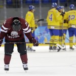 Latvia forward Mikelis Redlihs skates off the ice head down after Latvia's 5-3 loss to Sweden during the 2014 Winter Olympics men's ice hockey game at Shayba Arena Saturday, Feb. 15, 2014, in Sochi, Russia. (AP Photo/Mark Humphrey)