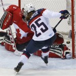 Alex Carpenter of the United States (25) scores a goal against Goalkeeper Shannon Szabados of Canada (1) during the third period of the women's gold medal ice hockey game at the 2014 Winter Olympics, Thursday, Feb. 20, 2014, in Sochi, Russia. (AP Photo/Petr David Josek)