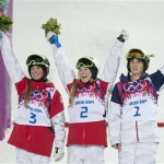 Gold medalist Canada's Justine Dufour-Lapointe, center, her sister and silver medalist Chloe Dufour-Lapointe, and bronze medalist United States' Hannah Kearney celebrate on the podum after the women's moguls freestyle skiing event at the Rosa Khutor Extreme Park, at the 2014 Sochi Winter Olympics, Saturday, Feb. 8, 2014, in Krasnaya Polyana, Russia. (AP Photo/The Canadian Press, Adrian Wyld)