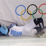 Vladimir Grigorev of Russia crashes out in a men's 500m short track speedskating quarterfinal at the Iceberg Skating Palace during the 2014 Winter Olympics, Friday, Feb. 21, 2014, in Sochi, Russia. (AP Photo/Vadim Ghirda)