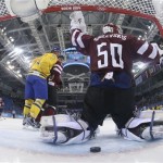 Latvia goalkeeper Kristers Gudlevskis reacts to Sweden forward Daniel Alfredsson goal during the second period of a men's ice hockey game at the 2014 Winter Olympics, Saturday, Feb. 15, 2014, in Sochi, Russia. (AP Photo/Brian Snyder, Reuters Pool)